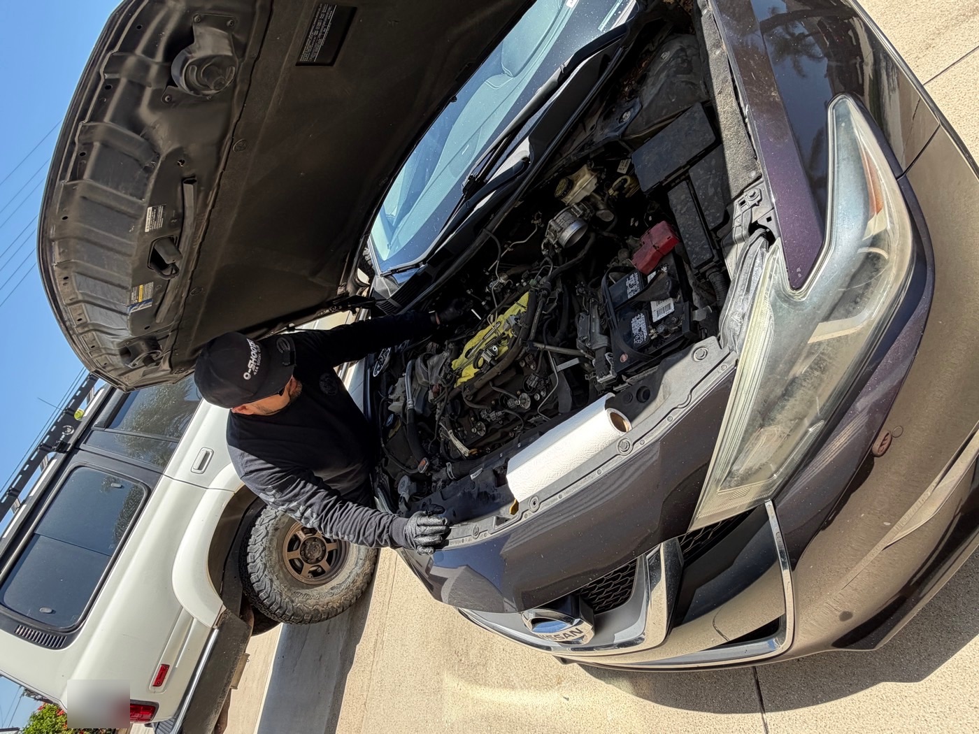 Close-up of Jay servicing an open engine bay